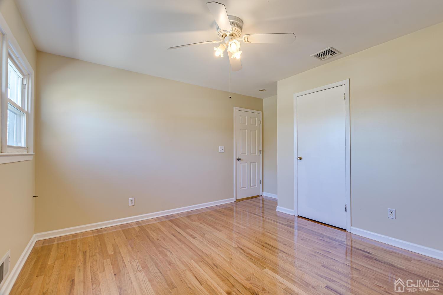 799 New Dover Road Edison, NJ 08820 - Photo 43 of 54 wooden floor in an empty room with a window