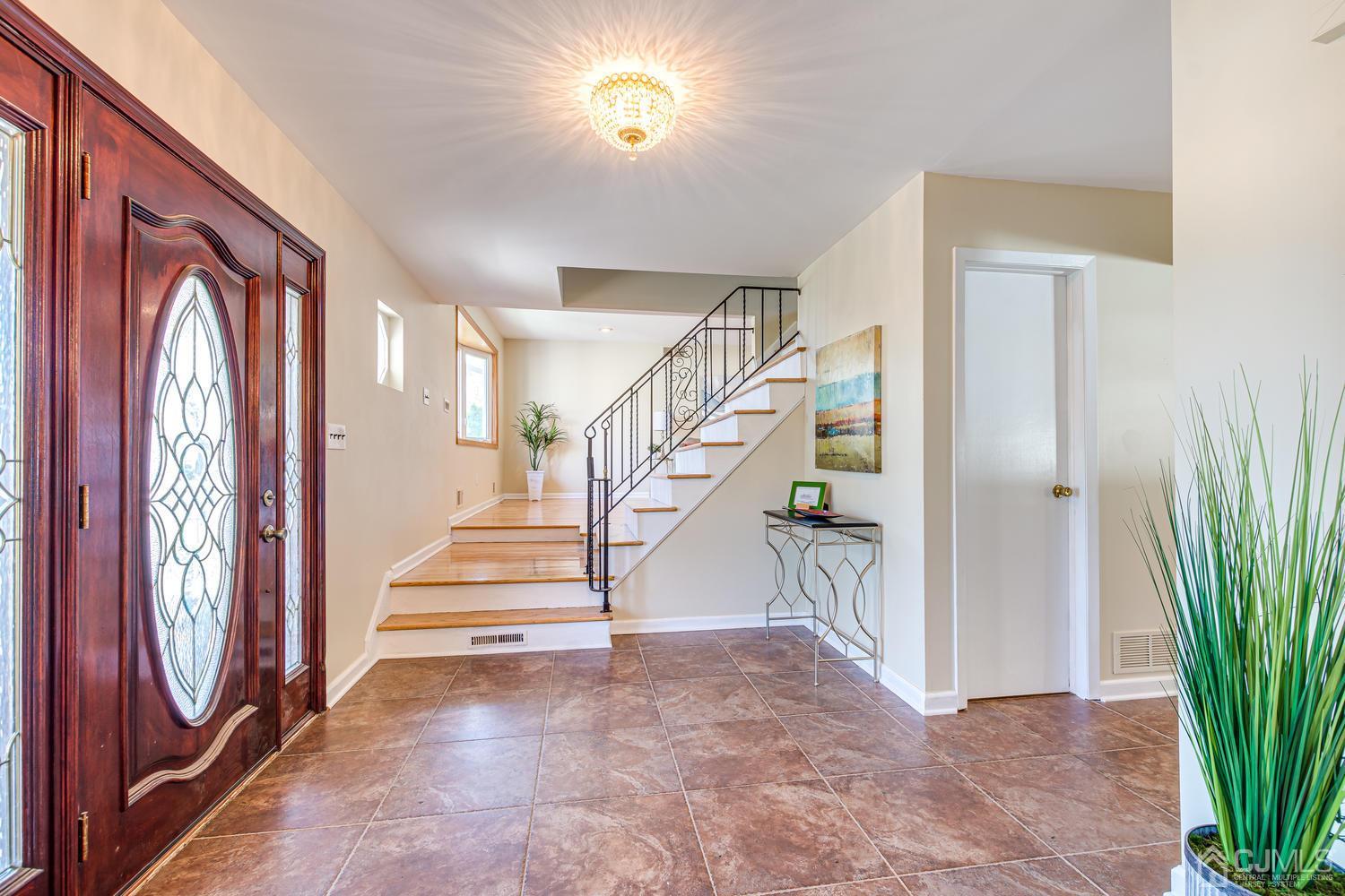 799 New Dover Road Edison, NJ 08820 - Photo 7 of 54 a view of entryway with wooden floor and a livingroom