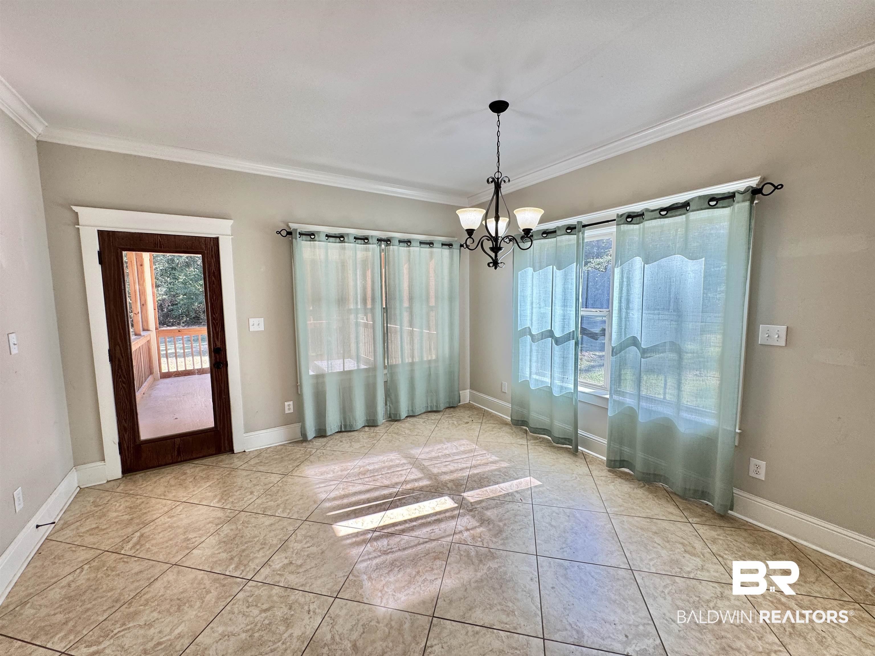 10846 County Road 138 Bay Minette, AL 36507 - Photo 22 of 53 Unfurnished dining area featuring crown molding, light tile patterned floors, and a chandelier