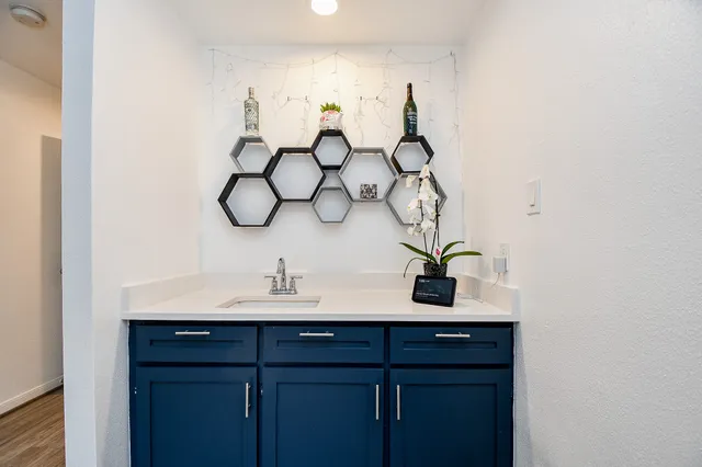 a view of a kitchen with stainless steel appliances a refrigerator and a chandelier
