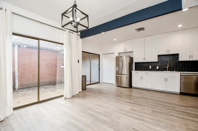 a view of a room with wooden floor
