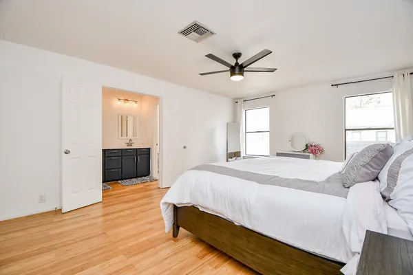 a bedroom with a bed and a ceiling fan