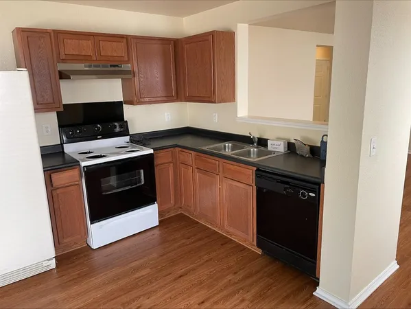 a kitchen with granite countertop a stove and a sink