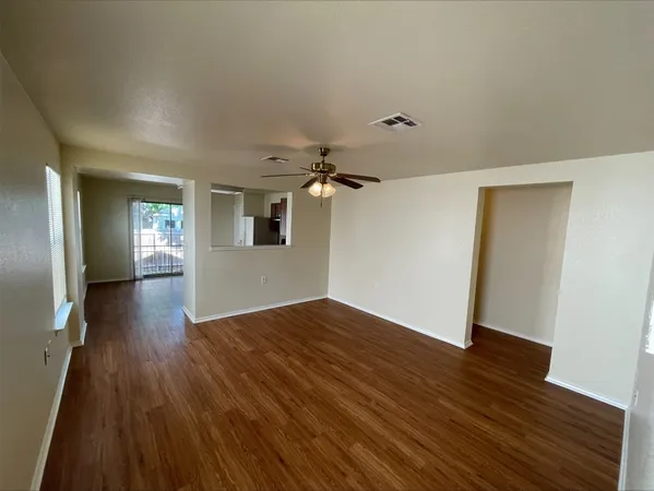 wooden floor in an empty room with a window