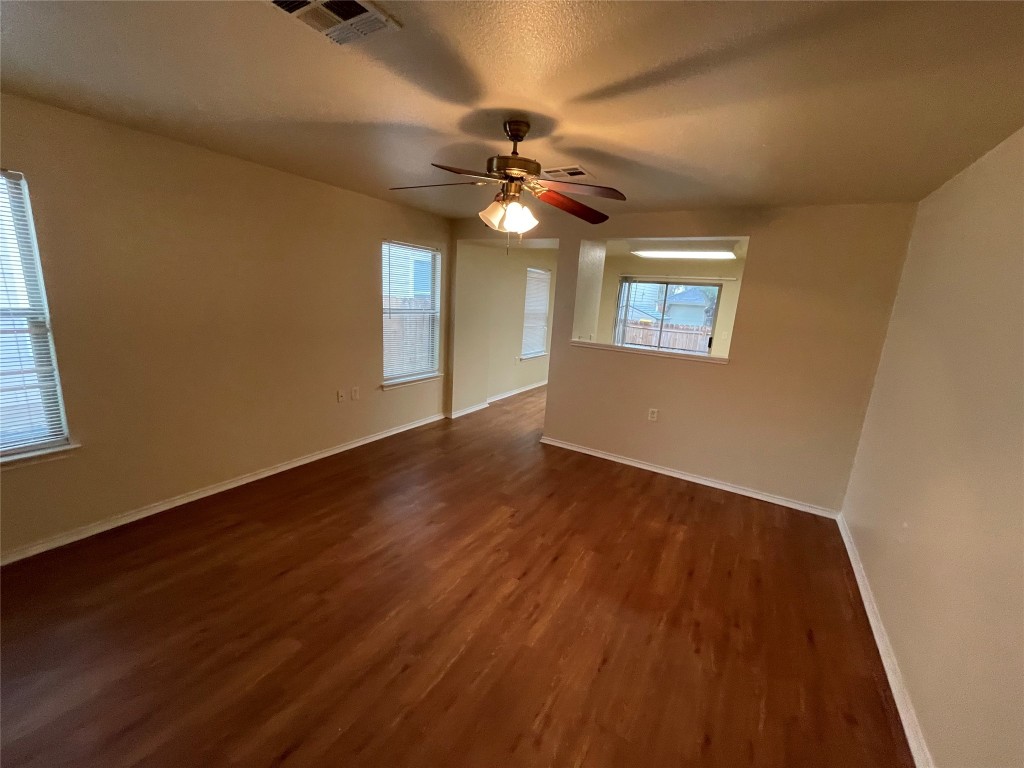 6912 Quinton Drive Austin, TX 78747 - Photo 7 of 24 a view of an empty room with window and wooden floor