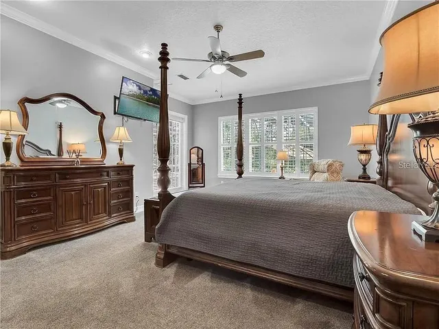 a bedroom with a bed and dresser with mirror