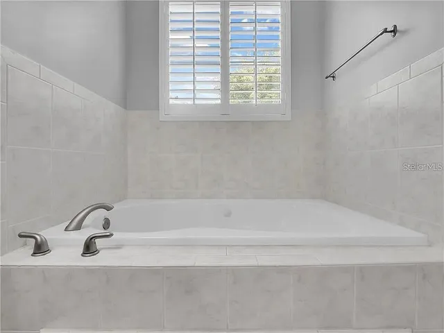 a bathroom with a shower and a window