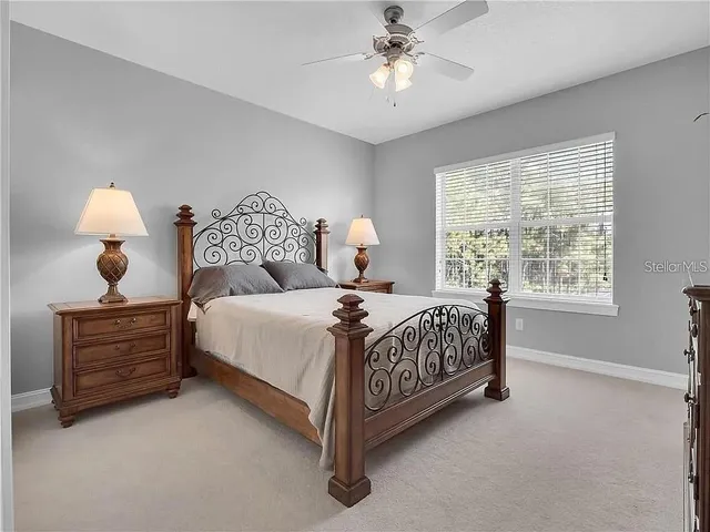 a bedroom with two beds and a large window