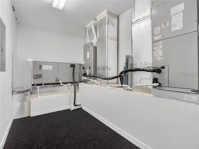 a utility room with sink dryer and washer