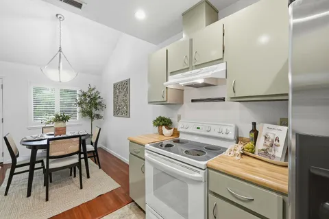 a kitchen with a white cabinets and chairs