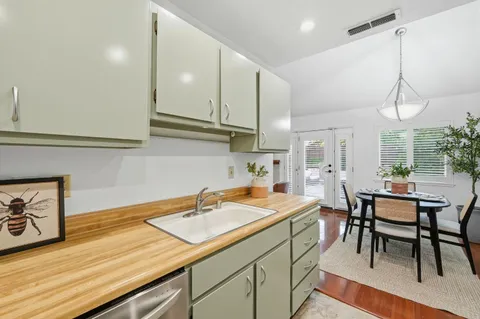 a kitchen with a sink cabinets and window
