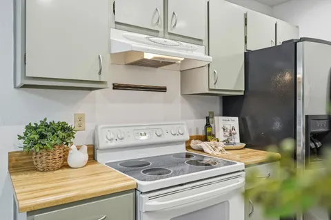 a kitchen with a refrigerator and cabinets