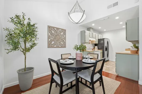a view of a dining room with furniture and wooden floor