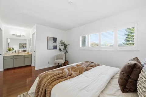 a bedroom with a bed and a large mirror