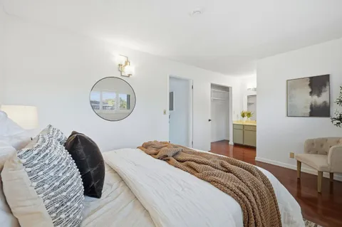 a bedroom with a bed and a mirror