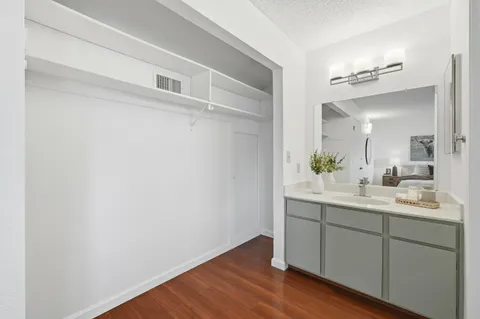 a bathroom with a sink double vanity granite toilet and shower