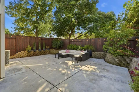 a view of a backyard with chairs and a fire pit