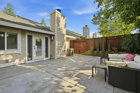 a view of backyard with outdoor seating and plants