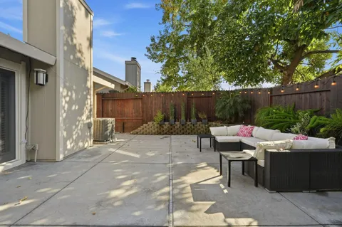 a view of backyard with furniture and plants