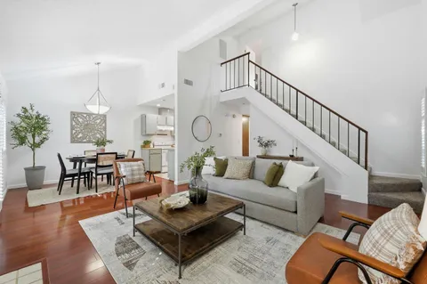 a living room with furniture a rug and a chandelier
