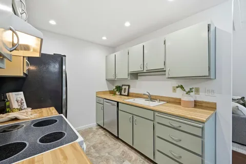 a kitchen with a sink and a stove