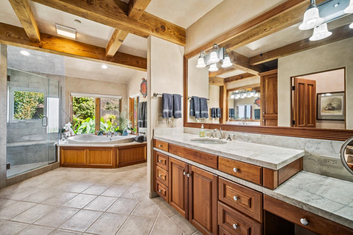 24 Mentone Road Carmel, CA 93923 - Photo 13 of 24 a spacious bathroom with a granite countertop sink and a bathtub