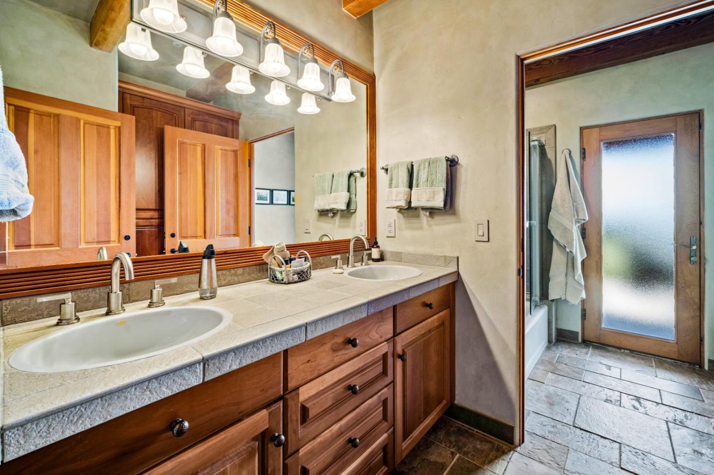 24 Mentone Road Carmel, CA 93923 - Photo 16 of 24 a bathroom with a double vanity sink and a mirror