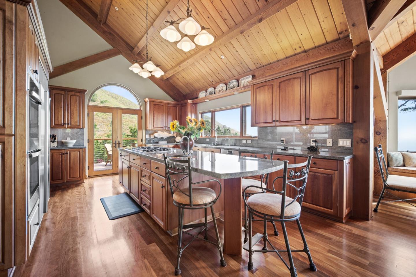 24 Mentone Road Carmel, CA 93923 - Photo 8 of 24 a kitchen with stainless steel appliances granite countertop a kitchen island hardwood floor and a window