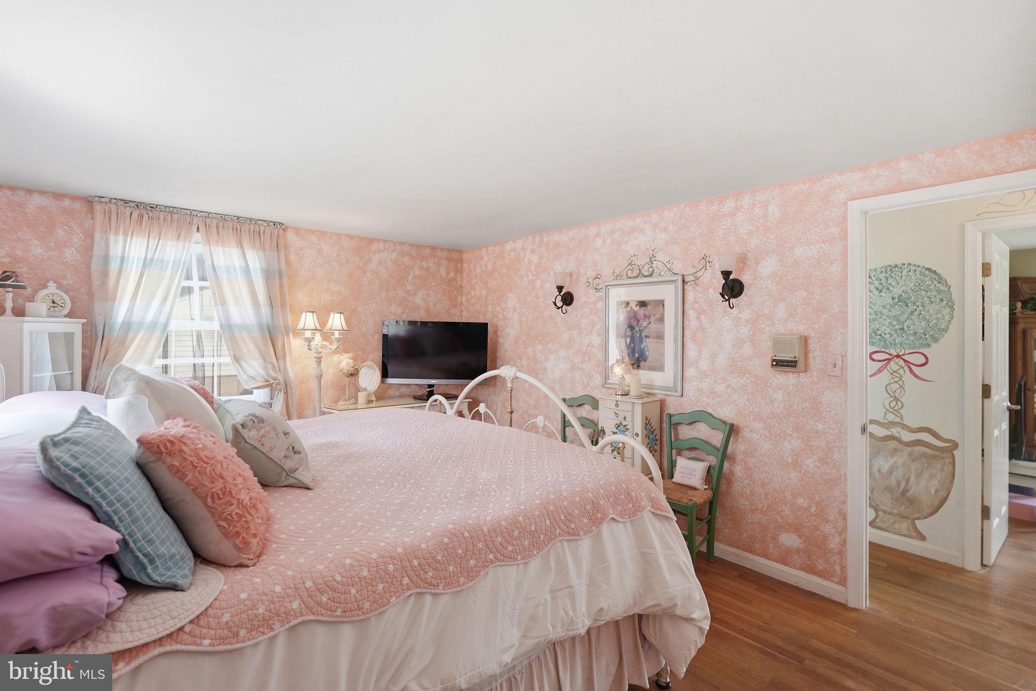 8406 Geneva Mason Road Potomac, MD 20854 - Photo 20 of 34 a bedroom with a bed and a flat screen tv