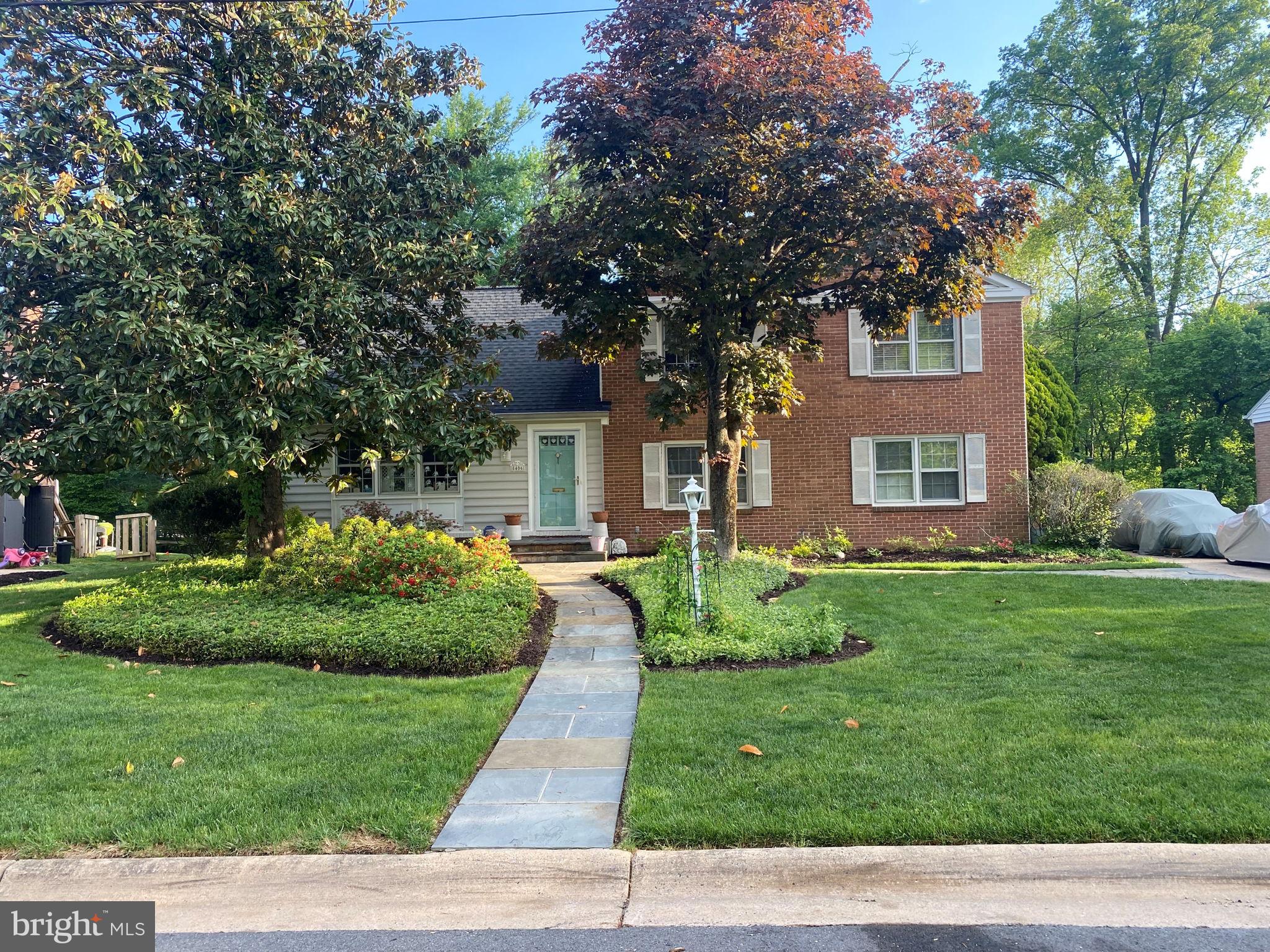 8406 Geneva Mason Road Potomac, MD 20854 - Photo 2 of 34 a front view of a house with a yard