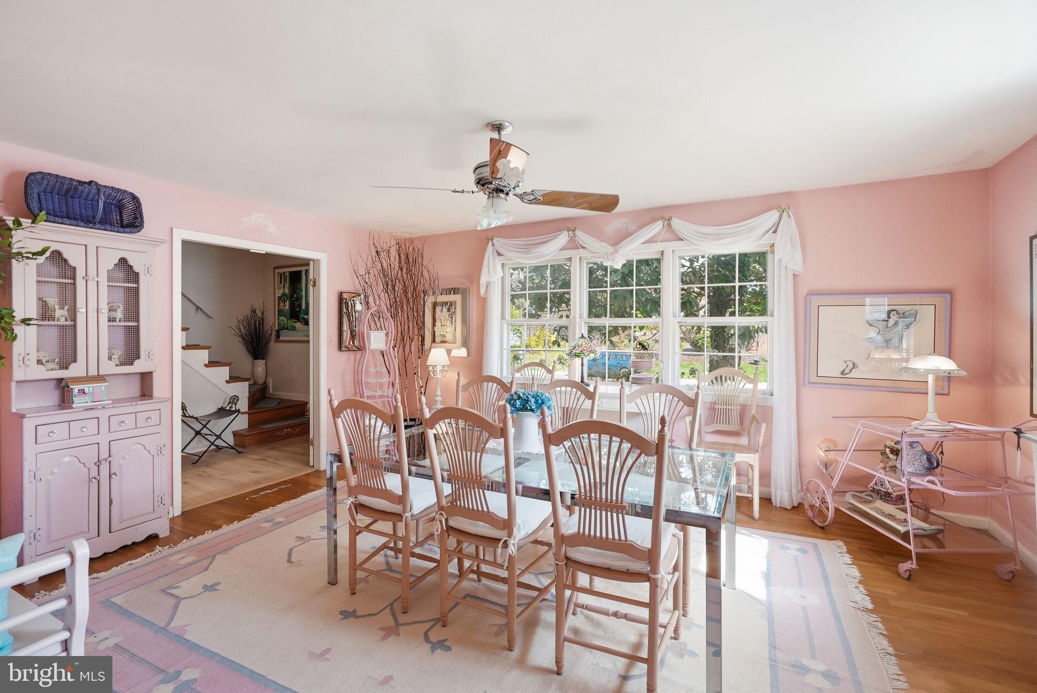 8406 Geneva Mason Road Potomac, MD 20854 - Photo 5 of 34 a view of a dining room with furniture a chandelier and wooden floor