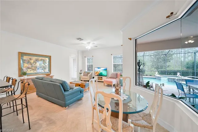 a view of a dining room with furniture large windows and wooden floor