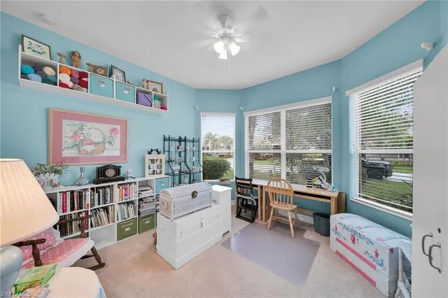 a dining room with furniture potted plants and a chandelier