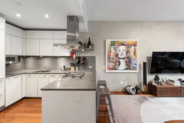 a kitchen with stainless steel appliances granite countertop a sink stove and cabinets