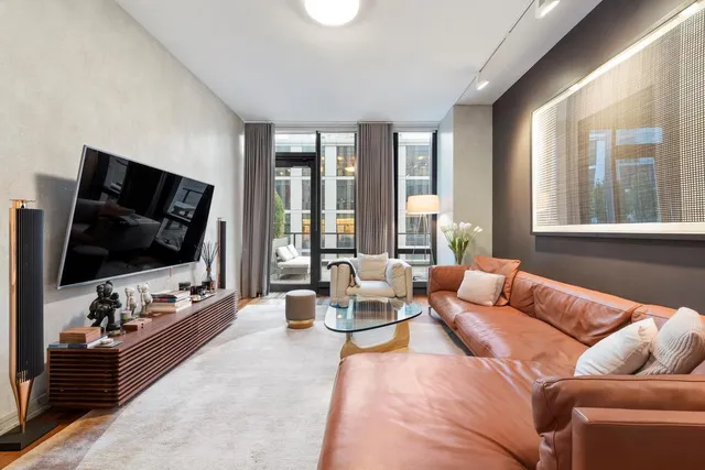 a living room with lots of furniture and a wooden floor