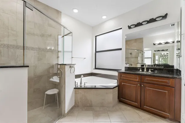 a bathroom with a granite countertop sink mirror and toilet