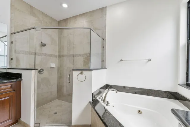 a bathroom with a bathtub and a shower
