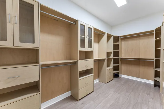 a view of walk in closet with empty racks