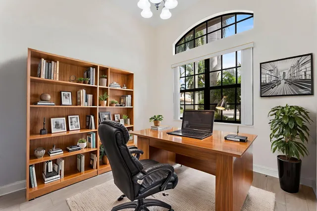 a work room with furniture lamp and book shelf