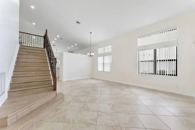 an empty room with windows and pillars in it