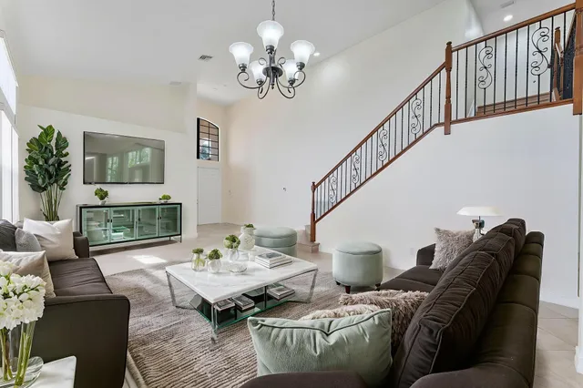 a living room with furniture and a chandelier
