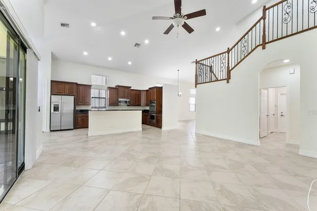 a view of a kitchen with refrigerator and a kitchen