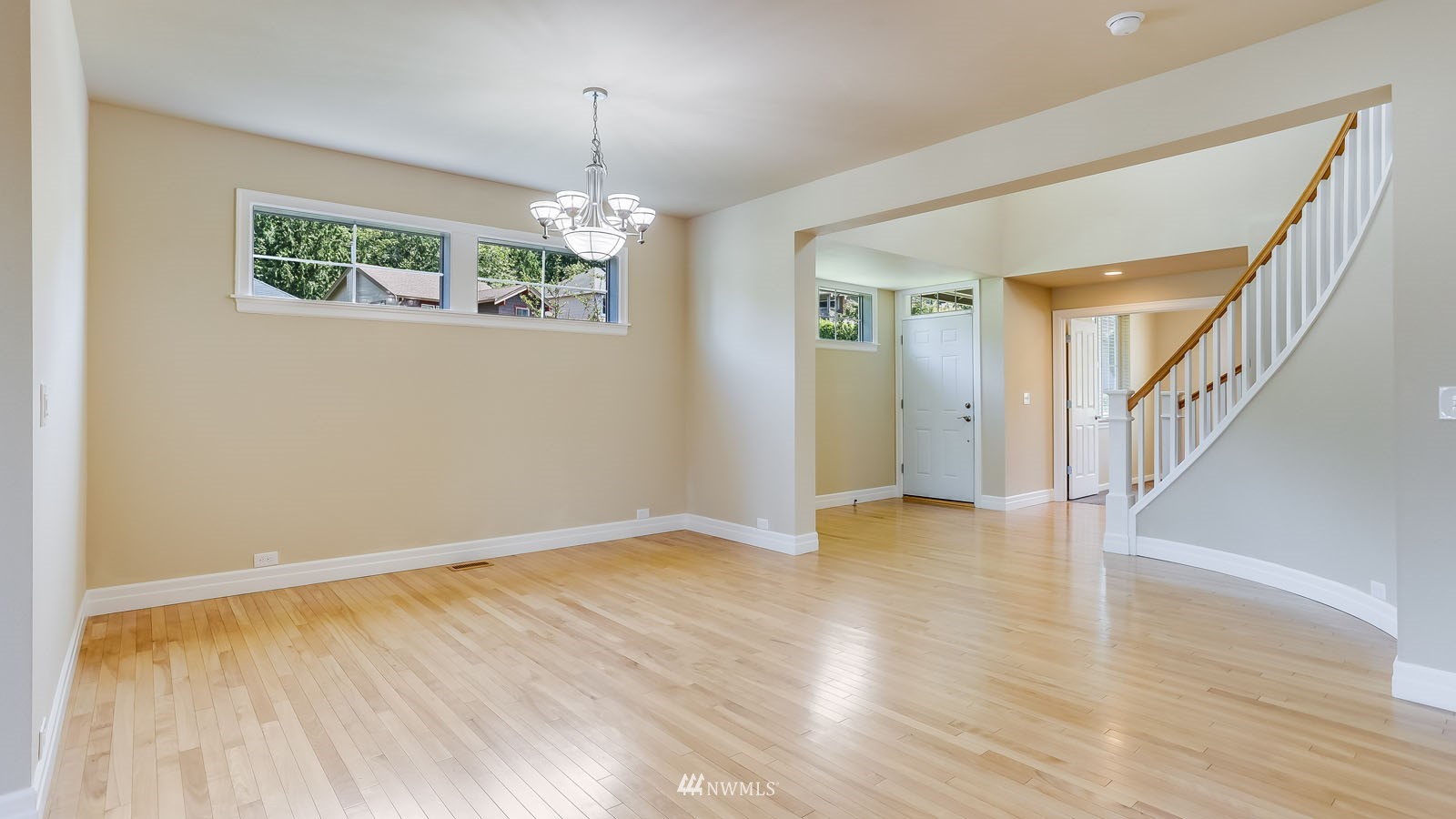 16458 Southeast 166th Terrace Renton, WA 98058 - Photo 13 of 40 a view of an empty room with wooden floor and a window