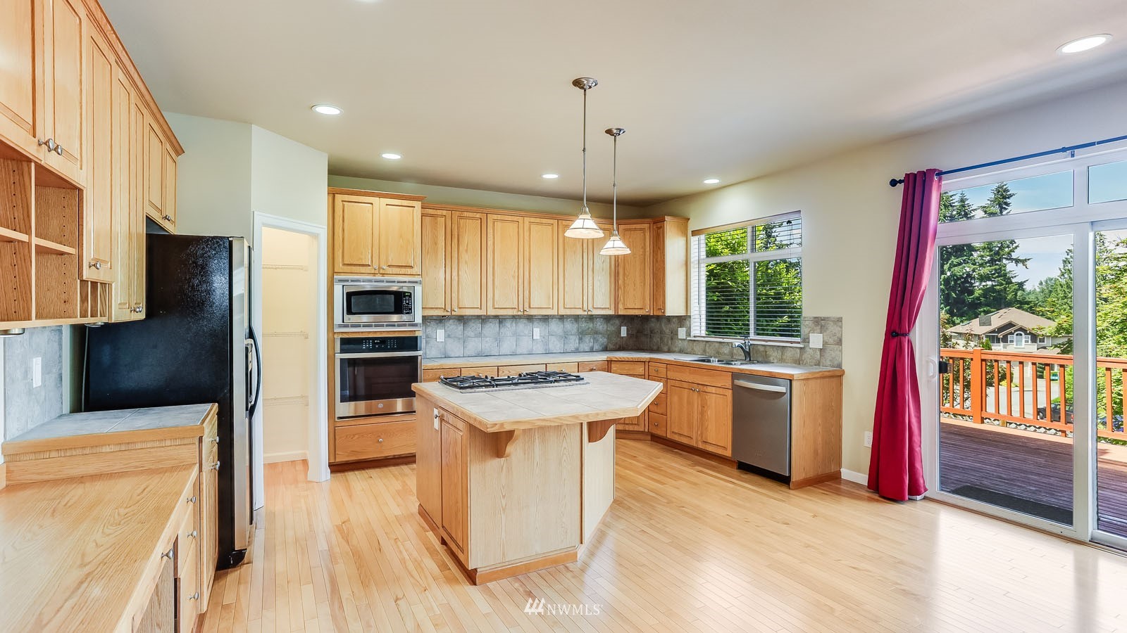 16458 Southeast 166th Terrace Renton, WA 98058 - Photo 21 of 40 a large kitchen with a large window and stainless steel appliances