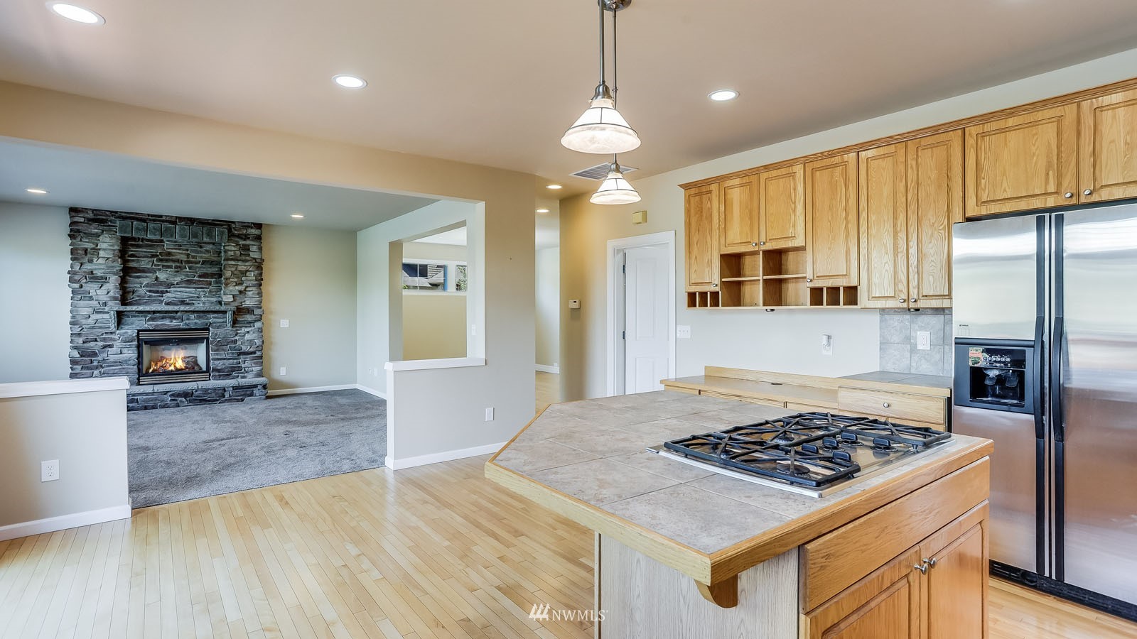 16458 Southeast 166th Terrace Renton, WA 98058 - Photo 22 of 40 a kitchen with stainless steel appliances granite countertop a stove refrigerator and cabinets