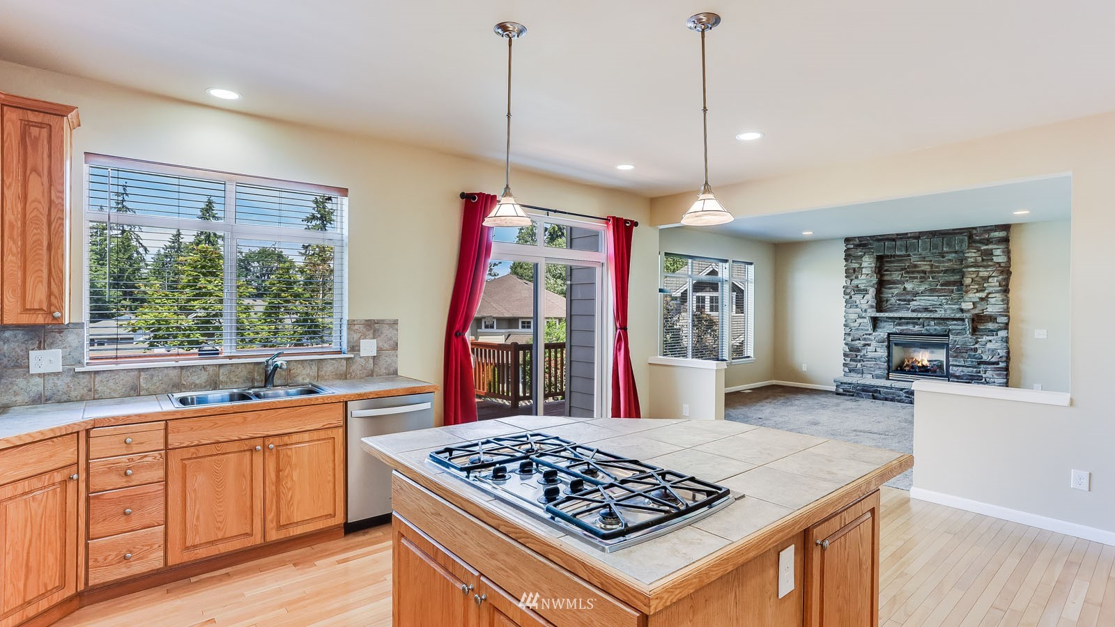 16458 Southeast 166th Terrace Renton, WA 98058 - Photo 23 of 40 a kitchen with stainless steel appliances granite countertop a sink stove and refrigerator