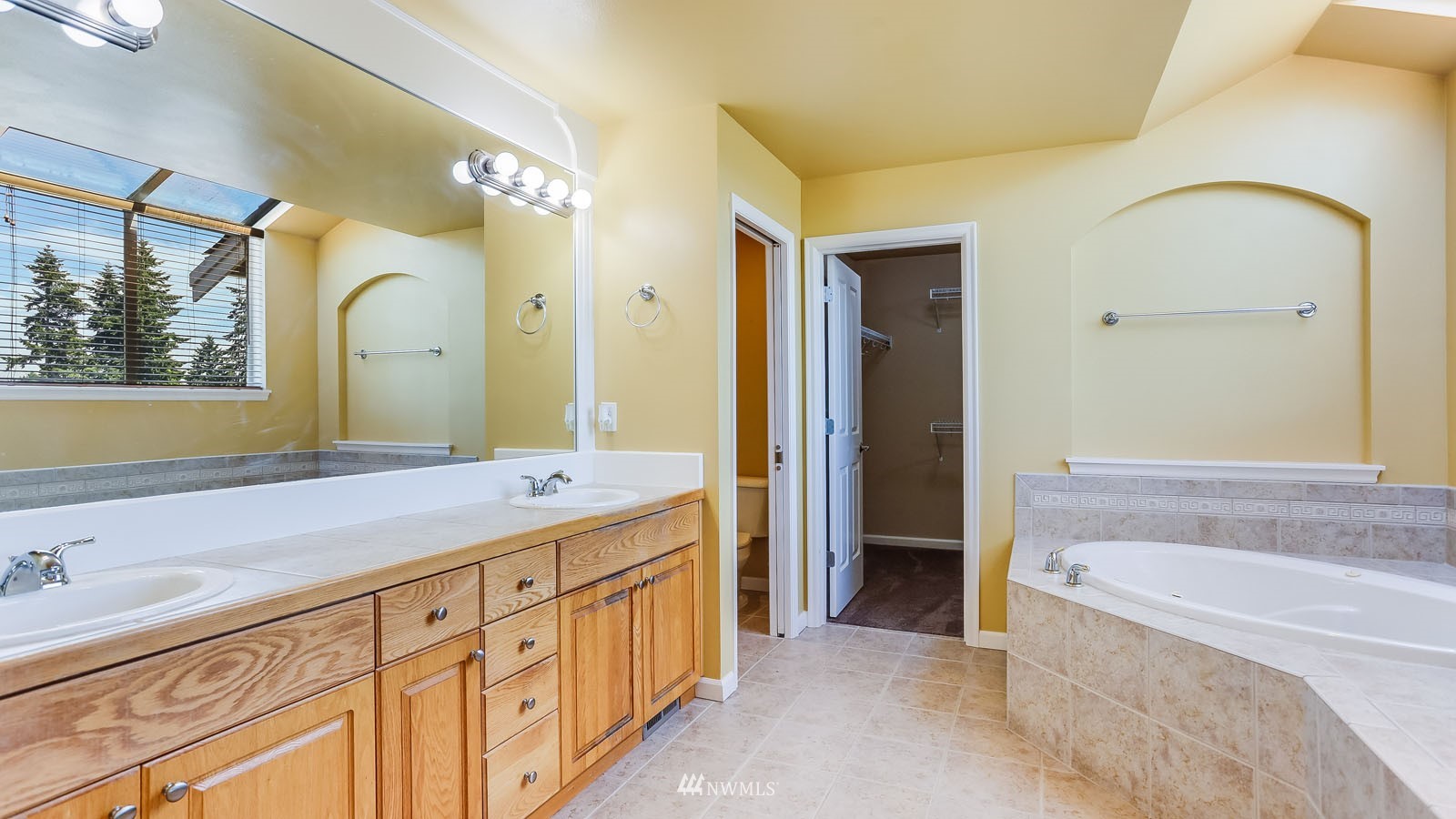 16458 Southeast 166th Terrace Renton, WA 98058 - Photo 31 of 40 a bathroom with a granite countertop sink mirror bathtub and shower