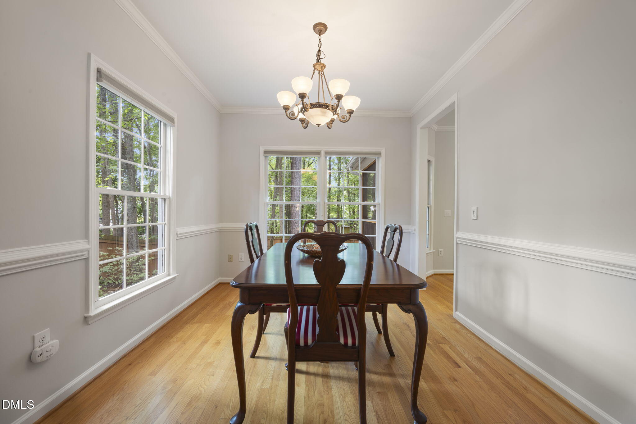 1008 Scotts Ridge Trail Apex, NC 27502 - Photo 18 of 57 a view of a dining room with furniture a chandelier and wooden floor