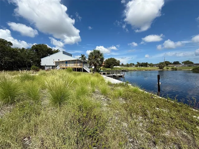 a view of a lake with houses in the back