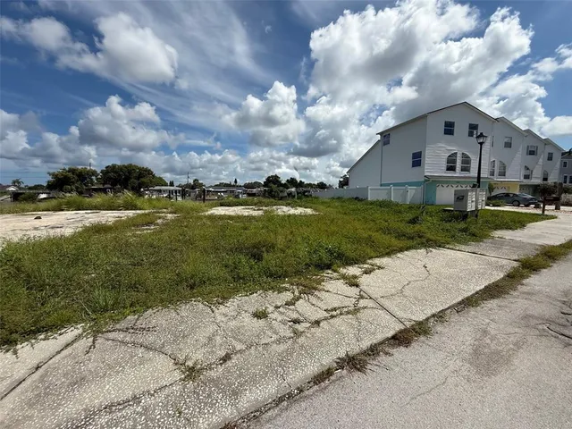 a view of a big house with a big yard and potted plants